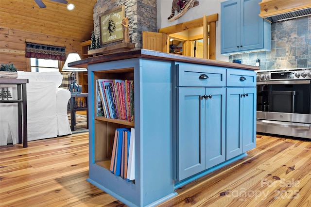 kitchen with blue cabinets, stainless steel electric range oven, extractor fan, and light wood-style flooring