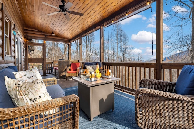 sunroom / solarium with vaulted ceiling, wooden ceiling, and a ceiling fan