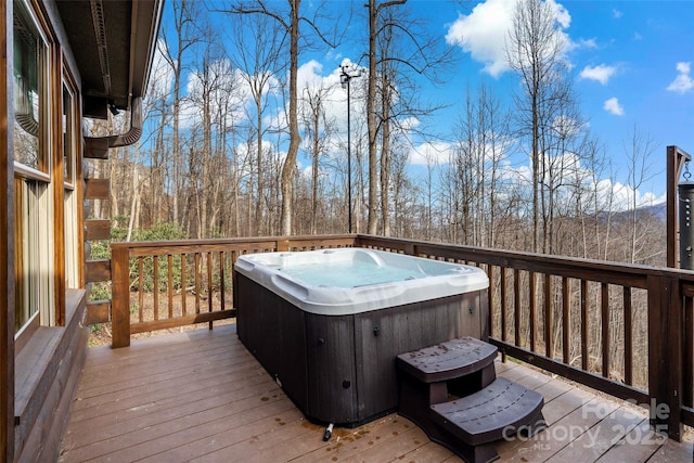 wooden terrace featuring a hot tub