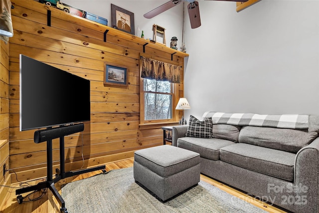 living room with wood finished floors and a ceiling fan