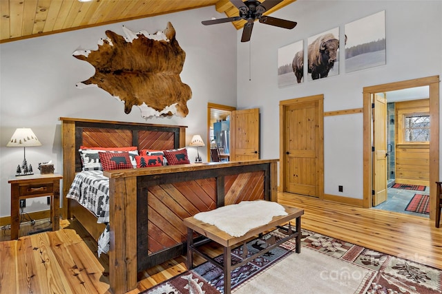 bedroom with hardwood / wood-style floors, wood ceiling, and high vaulted ceiling