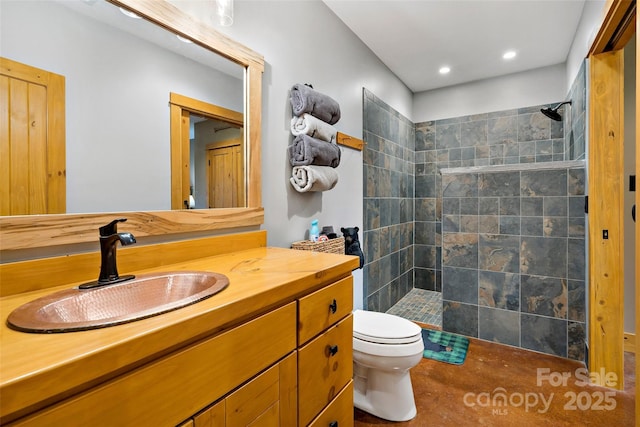 bathroom featuring recessed lighting, vanity, toilet, and a walk in shower