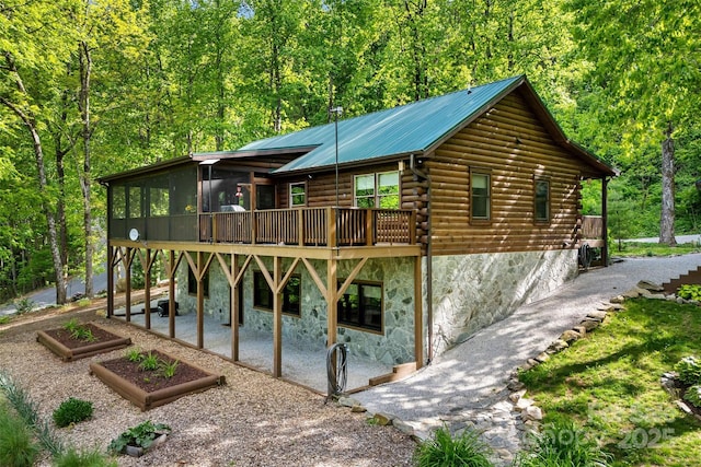 108 Oak Winds Dr Unit 202S, Old Fort, NC 28762 - rear view of house with a patio area, log siding, stone siding, a view of trees, and a sunroom