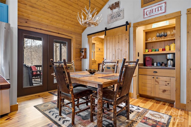 108 Oak Winds Dr Unit 202S, Old Fort, NC 28762 - dining space with vaulted ceiling, wooden ceiling, light wood finished floors, a barn door, and french doors