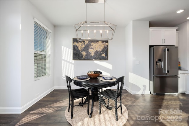 dining area featuring dark hardwood / wood-style floors and a notable chandelier