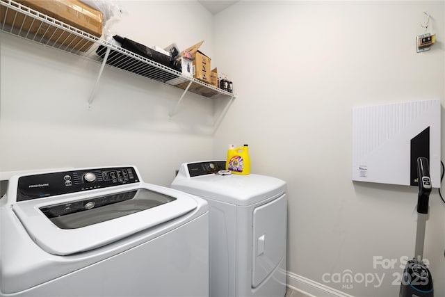 laundry room featuring washing machine and clothes dryer