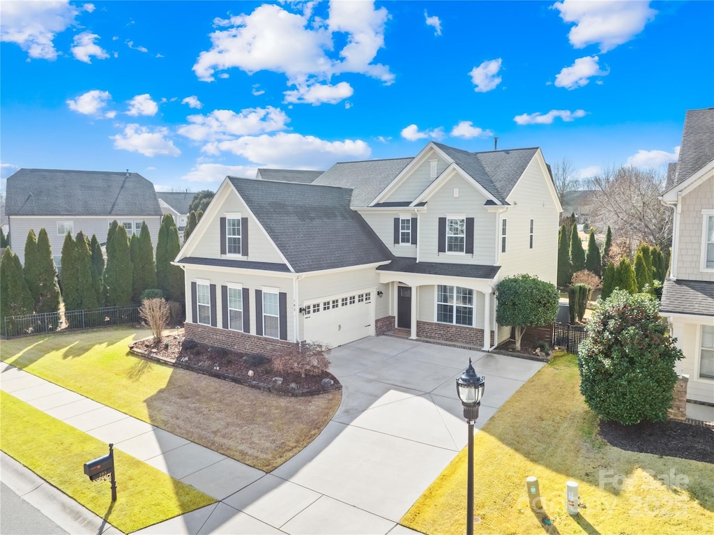 view of front of property with a garage and a front lawn