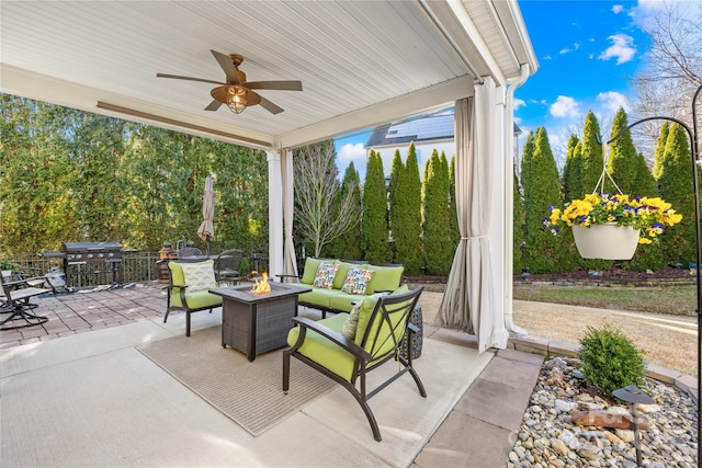 view of patio / terrace featuring area for grilling, an outdoor living space with a fire pit, and ceiling fan