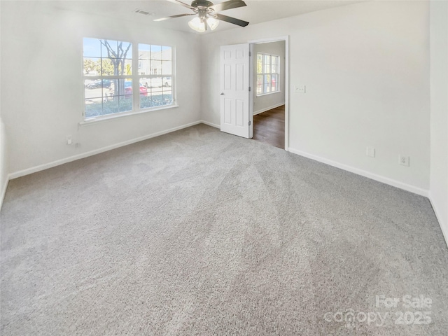 carpeted empty room featuring ceiling fan