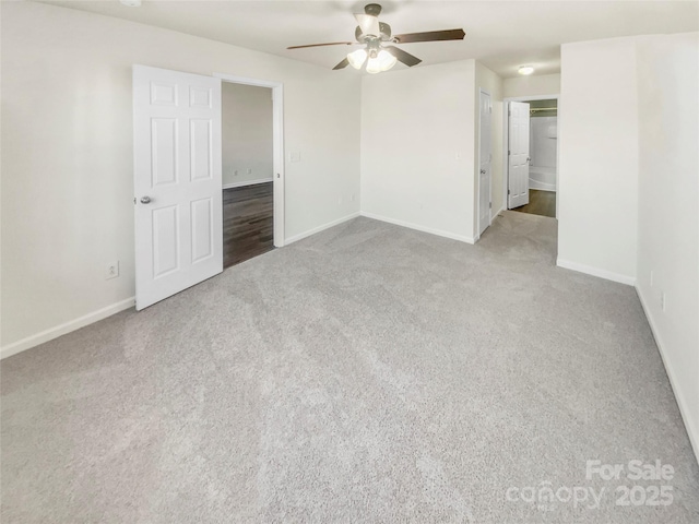 empty room featuring light colored carpet and ceiling fan