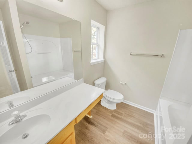 full bathroom with vanity, hardwood / wood-style floors, bathtub / shower combination, and toilet