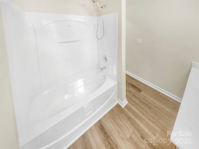 bathroom featuring hardwood / wood-style flooring and shower / bath combination