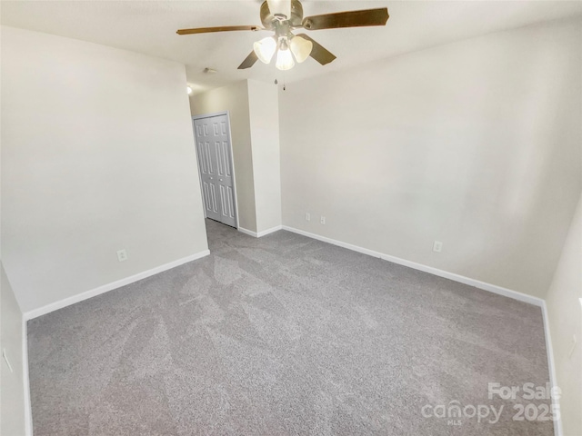 carpeted spare room with ceiling fan