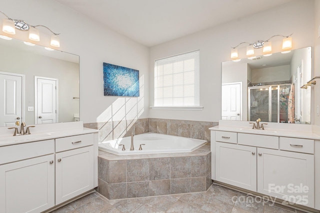 bathroom with independent shower and bath and vanity