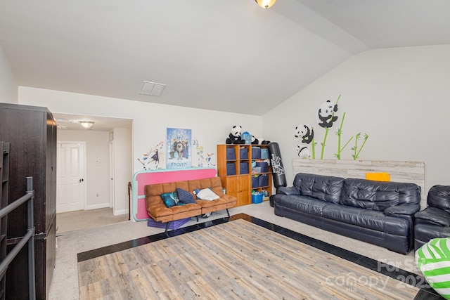 carpeted living room with vaulted ceiling