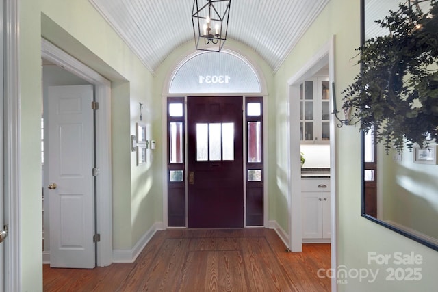 entryway with lofted ceiling and wood-type flooring