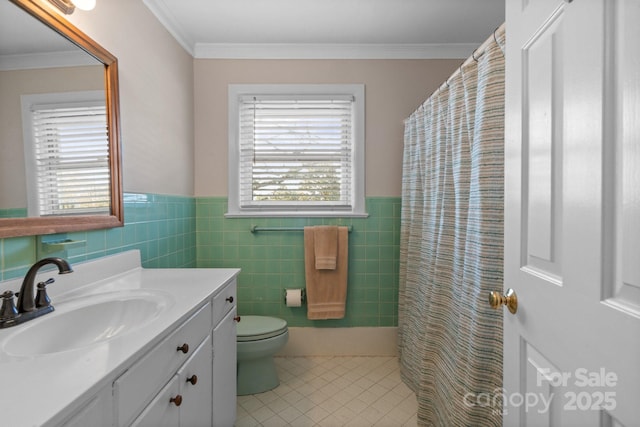 bathroom with tile walls, tile patterned flooring, vanity, toilet, and crown molding