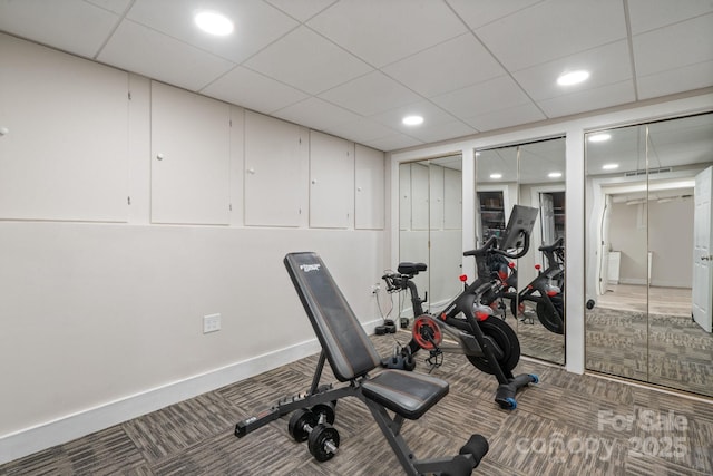 exercise area with carpet and a paneled ceiling