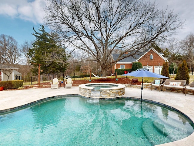 view of pool with an in ground hot tub and a patio