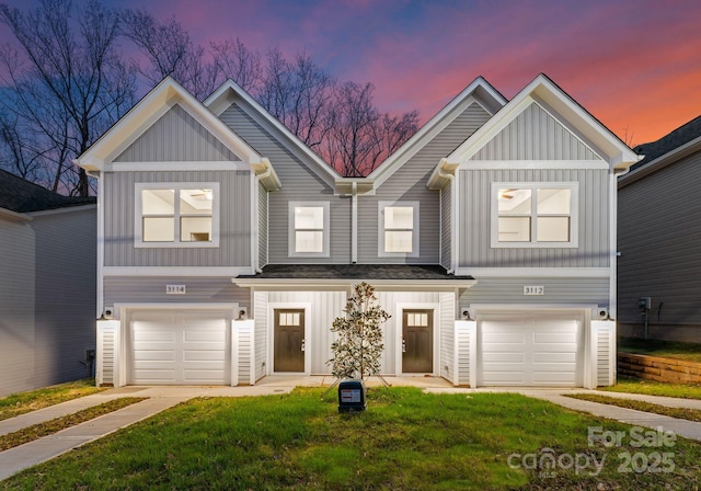 view of front of house with a garage and a yard