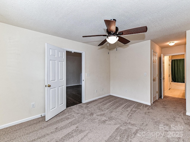 carpeted spare room with ceiling fan and a textured ceiling