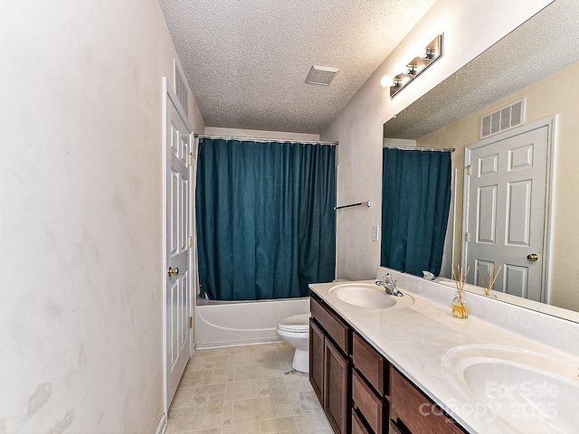 full bathroom featuring shower / tub combo with curtain, vanity, toilet, and a textured ceiling