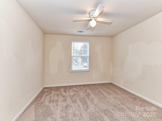 carpeted empty room featuring a textured ceiling and ceiling fan