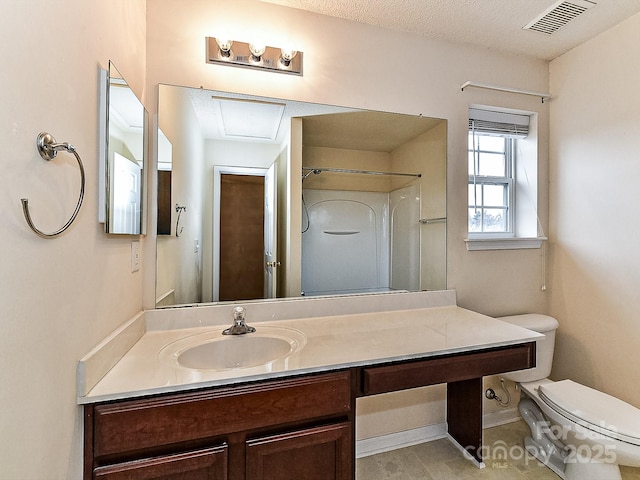 bathroom featuring vanity, toilet, a textured ceiling, and walk in shower