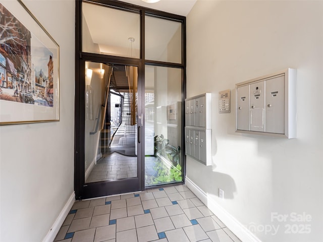 doorway featuring light tile patterned floors and a mail area