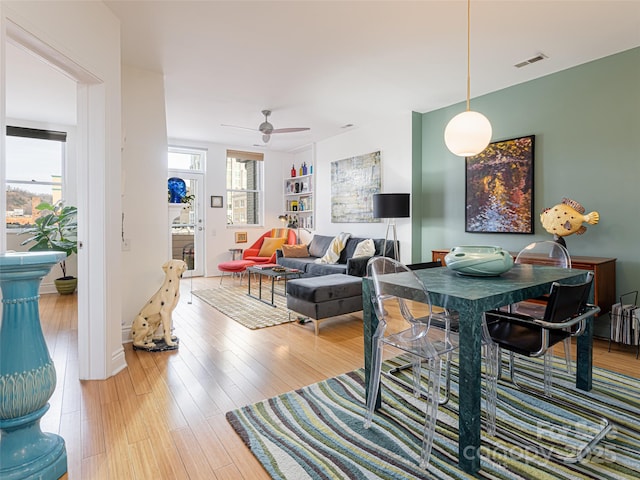 living room with hardwood / wood-style floors and ceiling fan