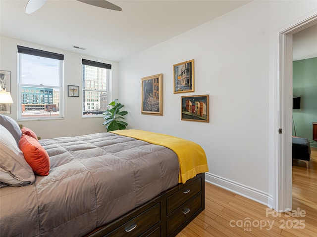 bedroom featuring ceiling fan and light hardwood / wood-style flooring