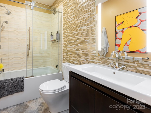 full bathroom featuring enclosed tub / shower combo, vanity, backsplash, and toilet