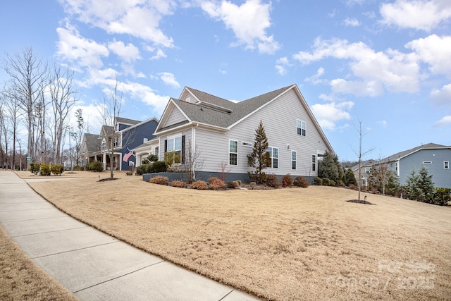 view of property exterior featuring a lawn