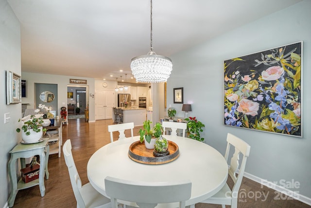 dining room featuring wood-type flooring and a notable chandelier