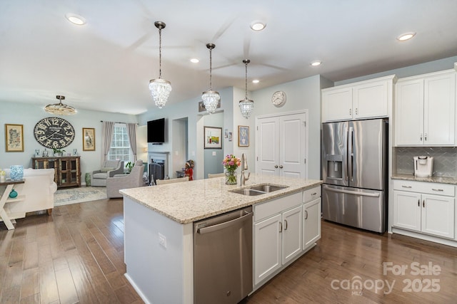 kitchen with white cabinetry, sink, pendant lighting, and appliances with stainless steel finishes