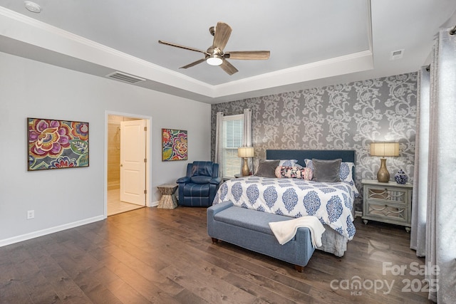 bedroom with dark wood-type flooring, ceiling fan, crown molding, and a raised ceiling