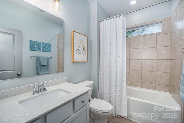 full bathroom featuring vanity, toilet, and shower / bath combo with shower curtain