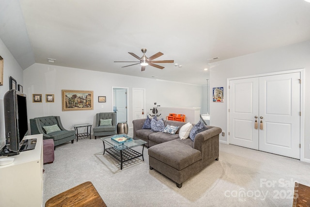 living room featuring light carpet, lofted ceiling, and ceiling fan