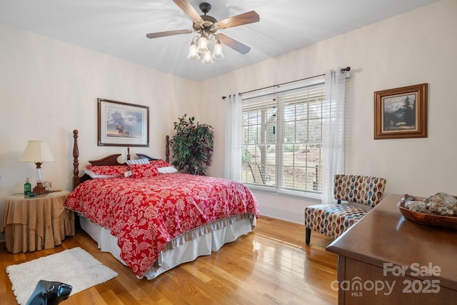 bedroom with hardwood / wood-style floors and ceiling fan