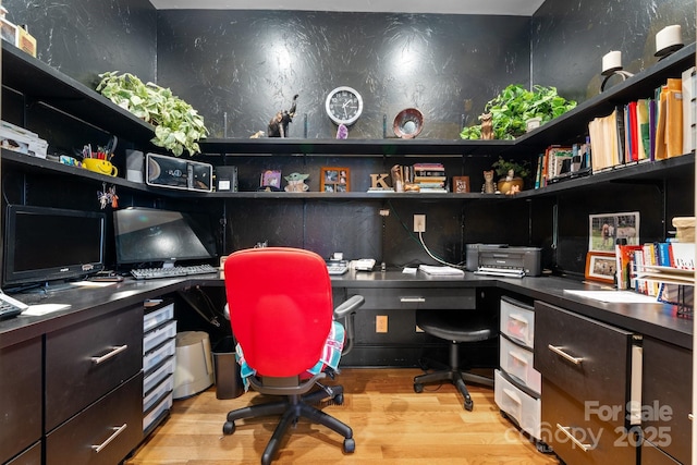 office with built in desk and light hardwood / wood-style floors