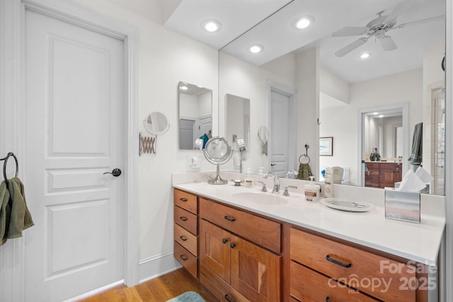 bathroom featuring vanity, hardwood / wood-style floors, and ceiling fan