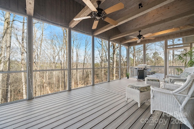 sunroom featuring a healthy amount of sunlight and ceiling fan