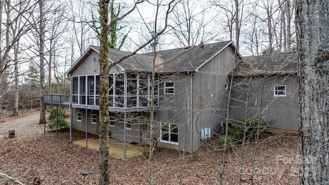 back of house with a sunroom and a patio area