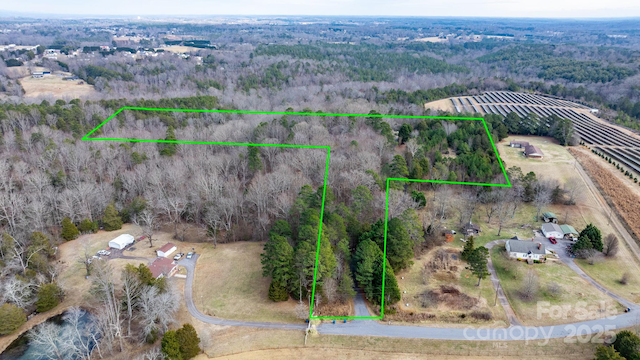 drone / aerial view featuring a rural view and a forest view