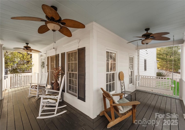 deck with covered porch and ceiling fan