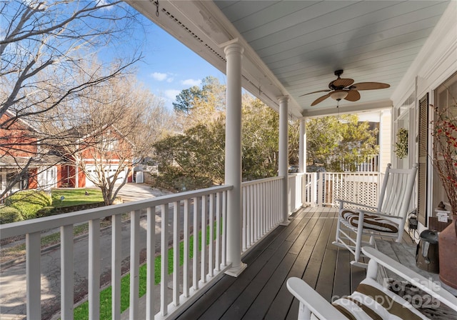 wooden deck with covered porch and ceiling fan