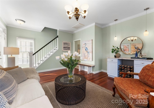 living room with dark wood-style flooring, visible vents, crown molding, and stairway