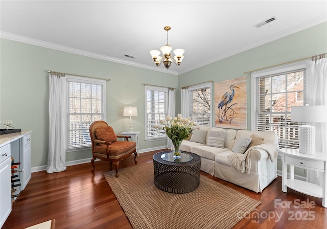 living area featuring dark wood-style floors, visible vents, an inviting chandelier, ornamental molding, and baseboards