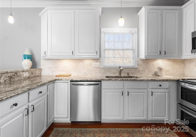 kitchen with stainless steel appliances, hanging light fixtures, and white cabinetry