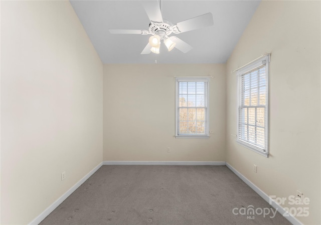 unfurnished room with a ceiling fan, lofted ceiling, light carpet, and baseboards